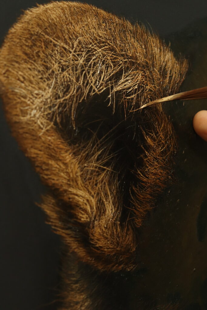 Close up look at the artist painting the ear.