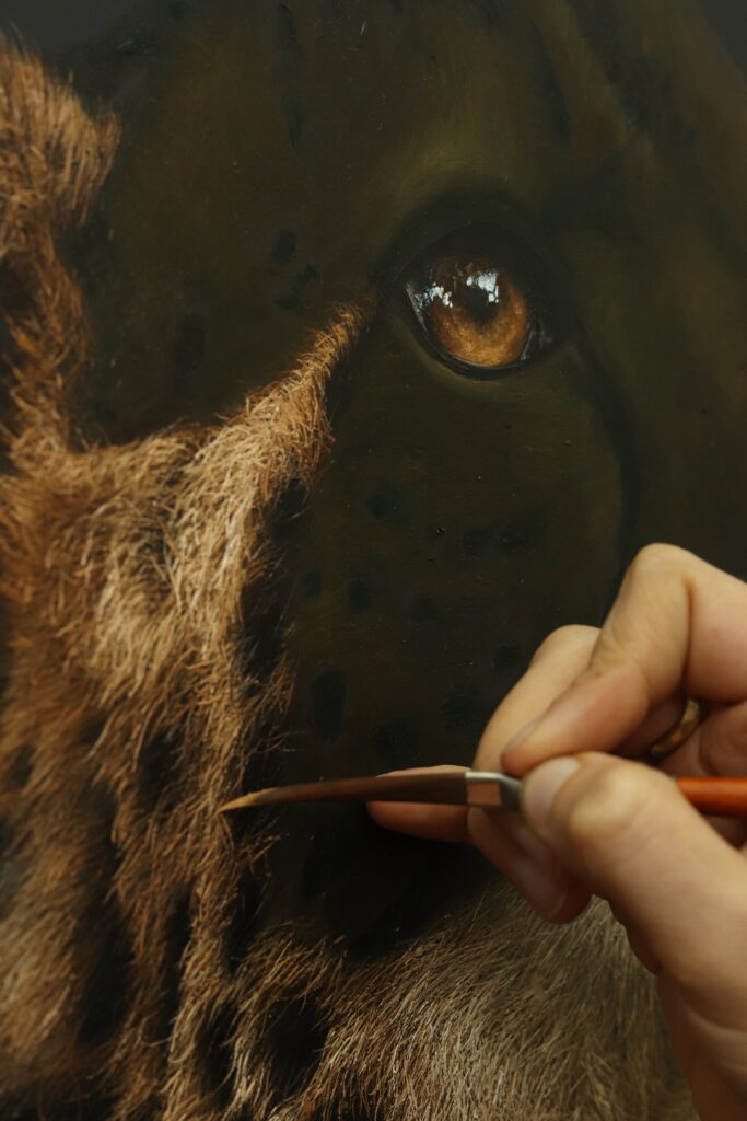 The artist working on the Cheetah painting