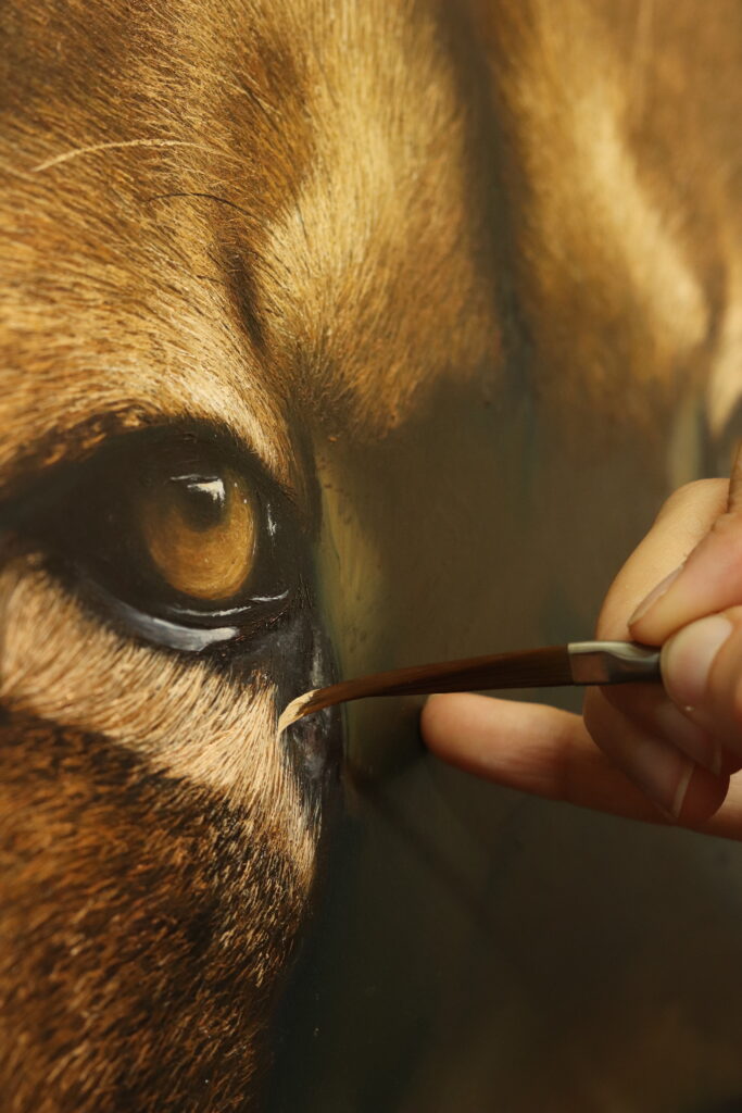 Close up of the artist working on the eye