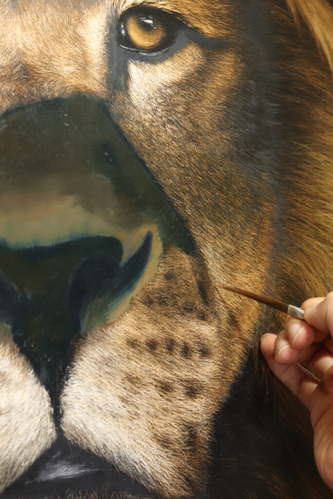 Close up of the artist working on the cheek