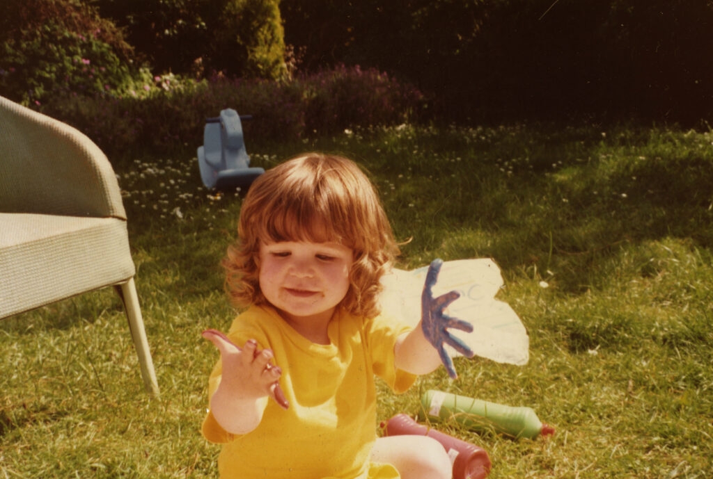 The artist as a child, painting in the garden.